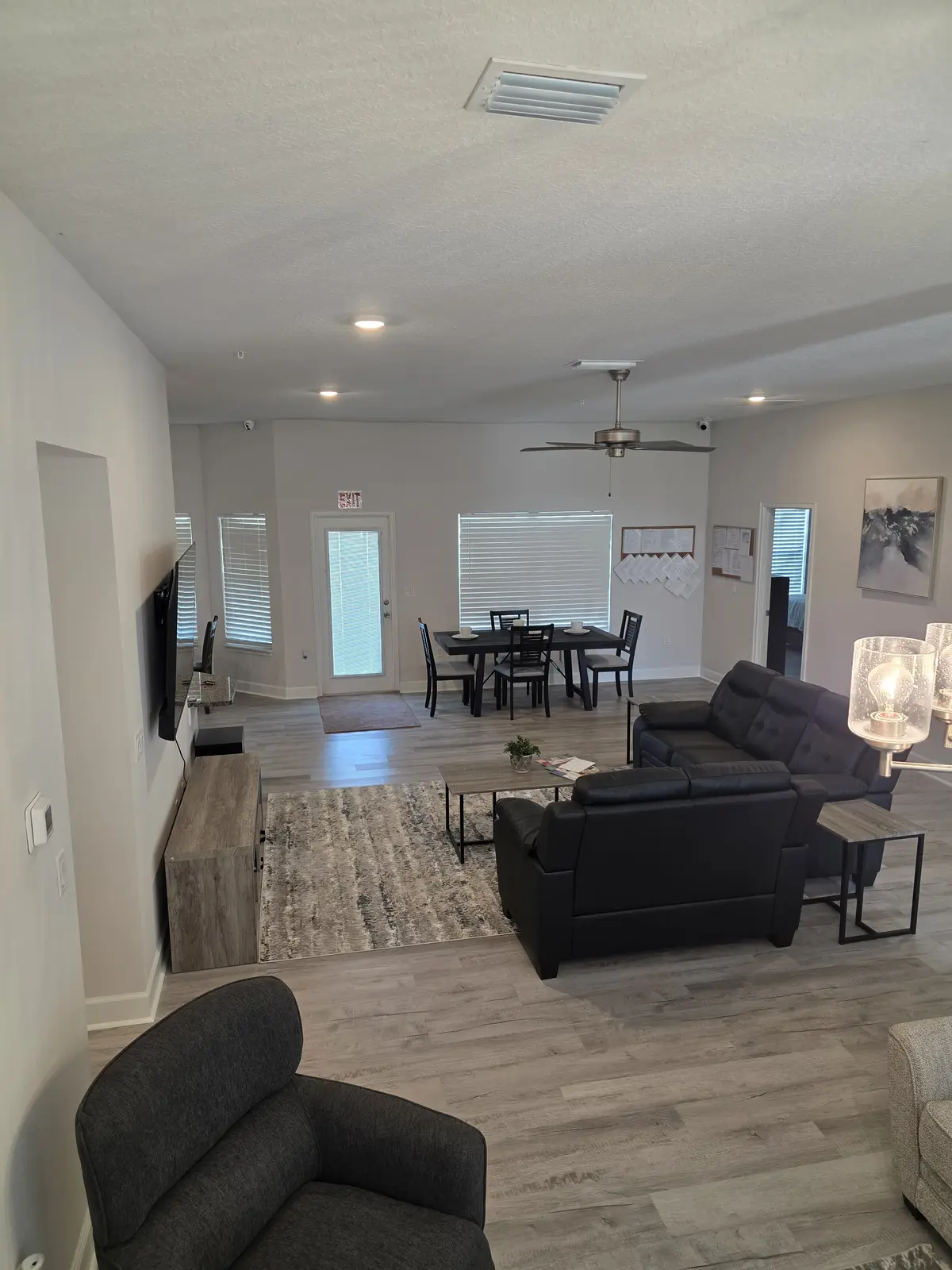 Spacious community lounge with multiple seating areas and dining space